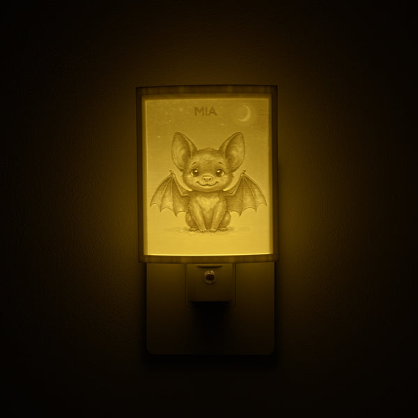 Bat night light glowing with the name MIA sculpted into the panel