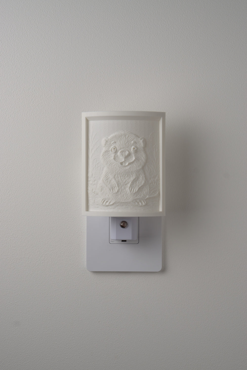 Beaver night light switched off — a soft ivory panel by day