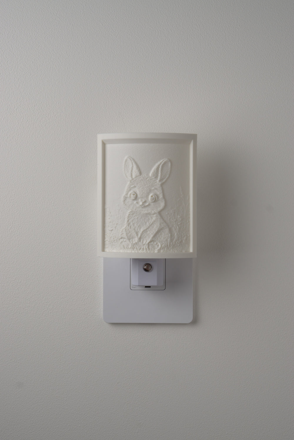 Bunny night light switched off — a soft ivory panel by day