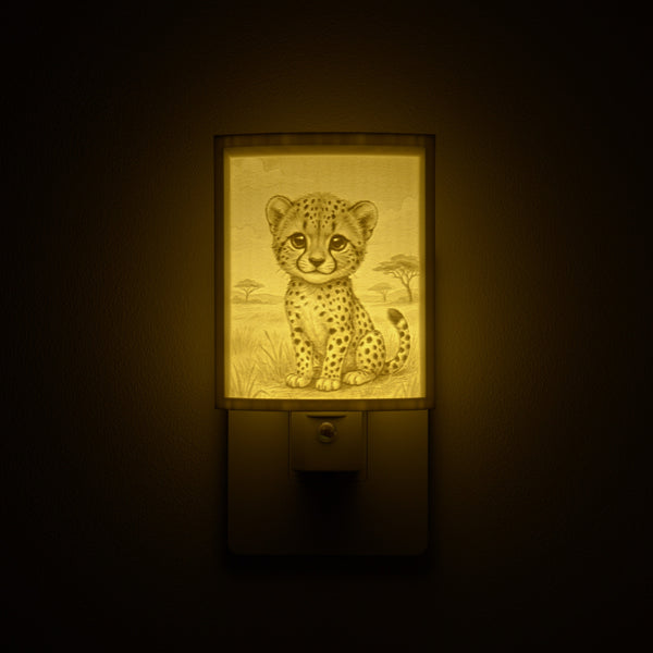Cheetah night light glowing against a dark wall, plugged into an outlet