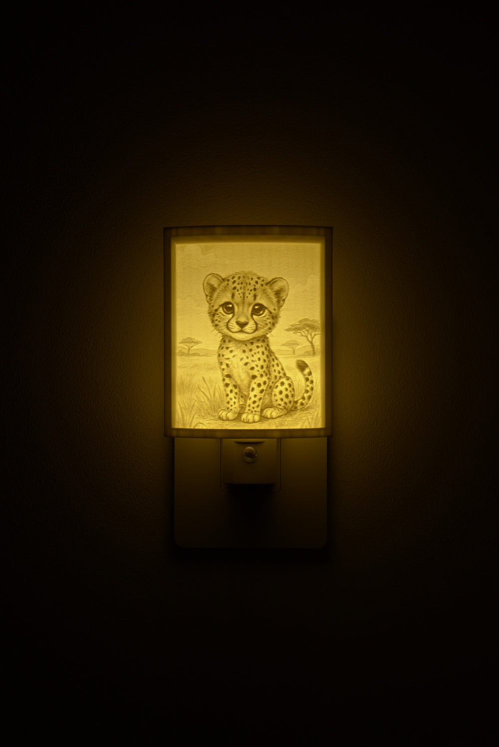 Cheetah night light glowing against a dark wall, plugged into an outlet
