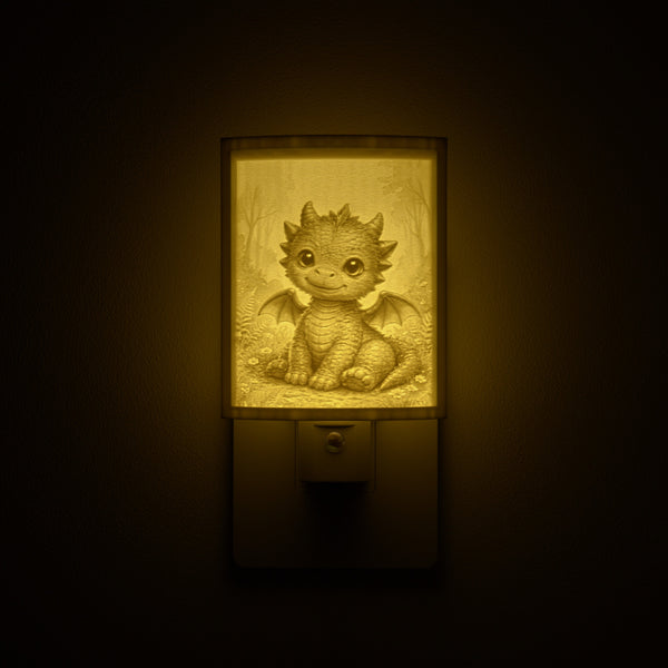 Dragon night light glowing against a dark wall, plugged into an outlet