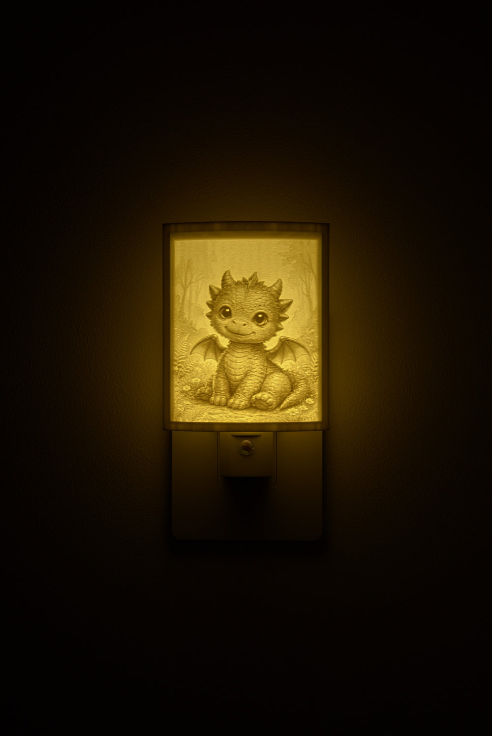Dragon night light glowing against a dark wall, plugged into an outlet