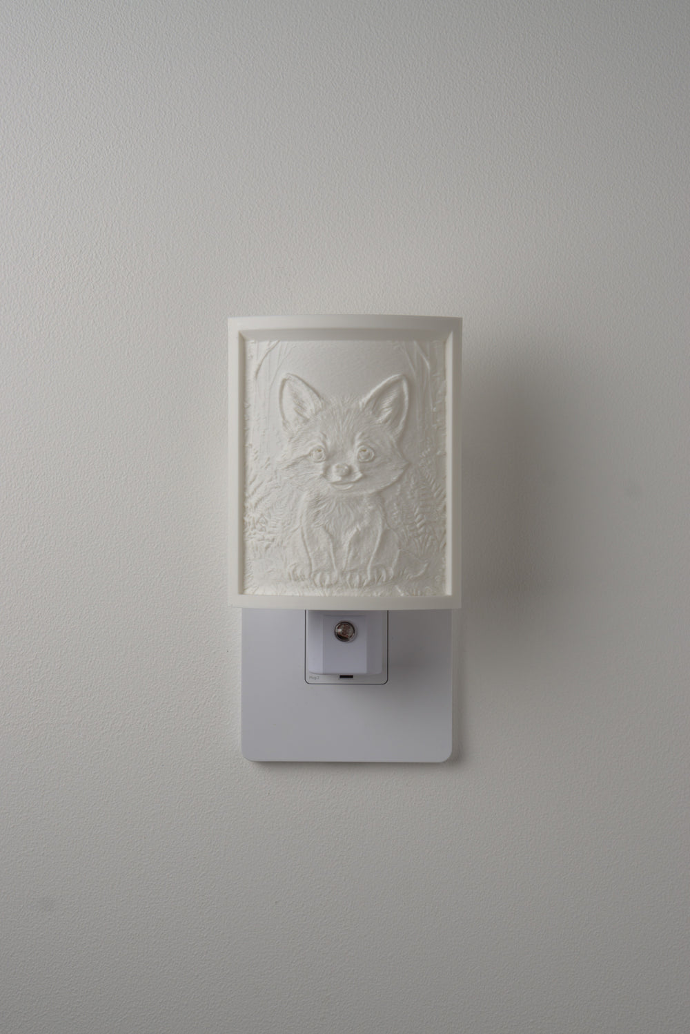 Fox night light switched off — a soft ivory panel by day