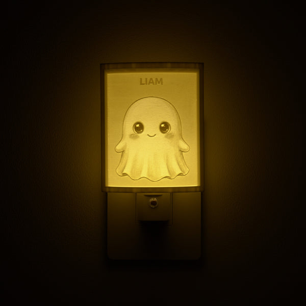 Ghost night light glowing with the name LIAM sculpted into the panel