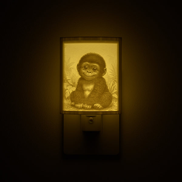 Gorilla night light glowing against a dark wall, plugged into an outlet