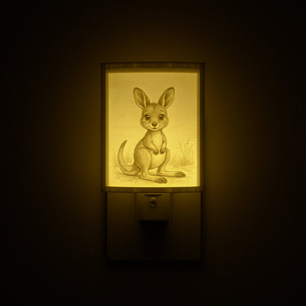 Joey night light glowing against a dark wall, plugged into an outlet