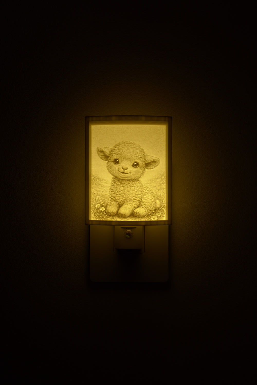 Lamb night light glowing against a dark wall, plugged into an outlet