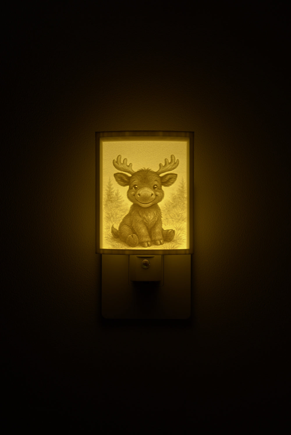 Moose night light glowing against a dark wall, plugged into an outlet