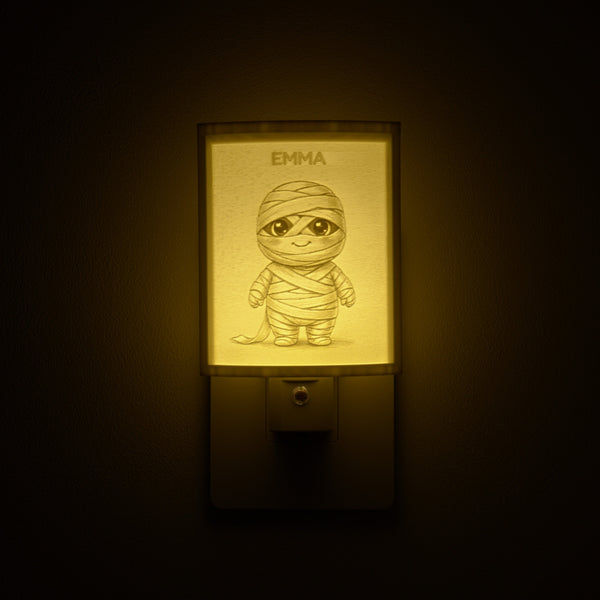 Mummy night light glowing with the name EMMA sculpted into the panel