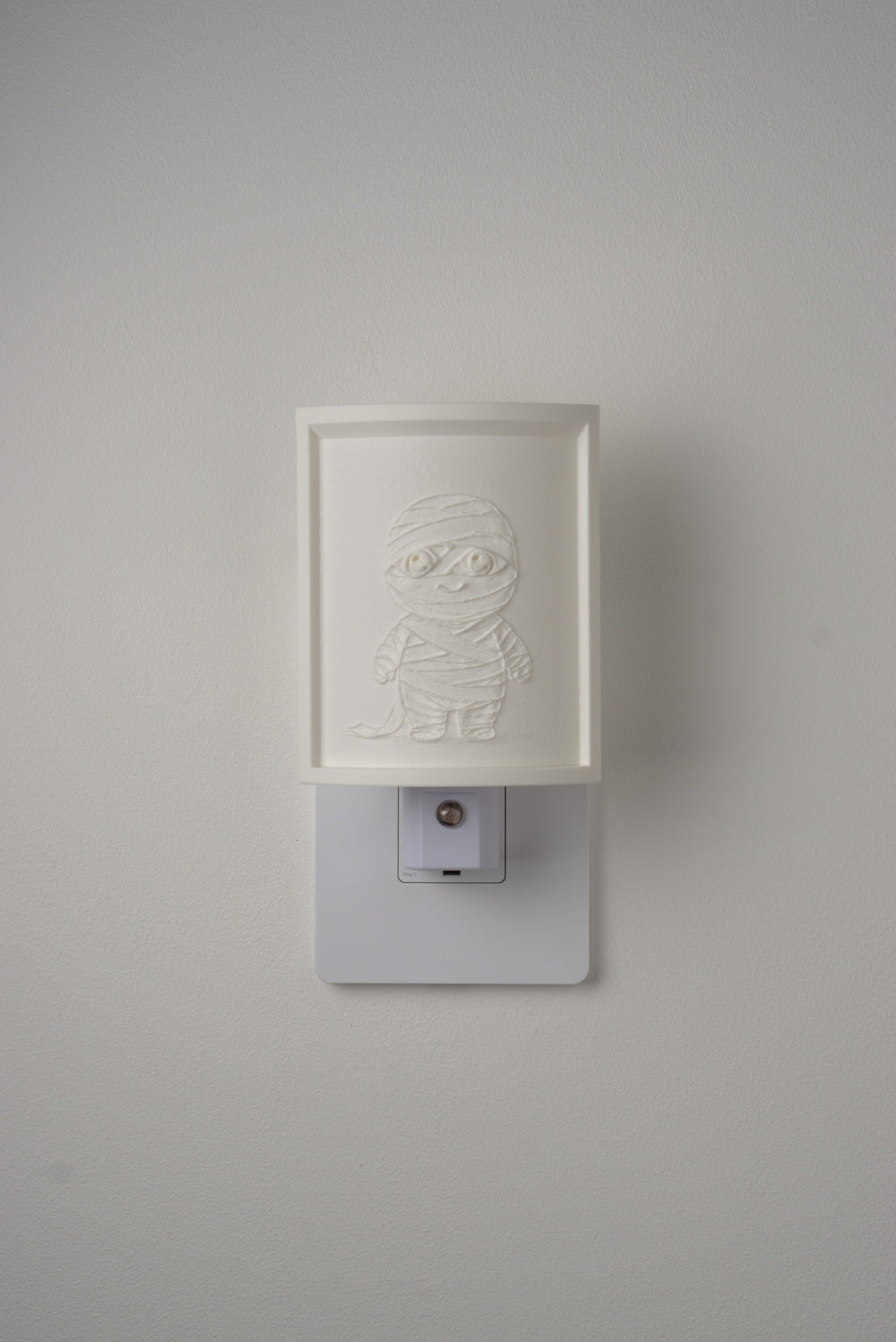 Mummy night light switched off — a soft ivory panel by day
