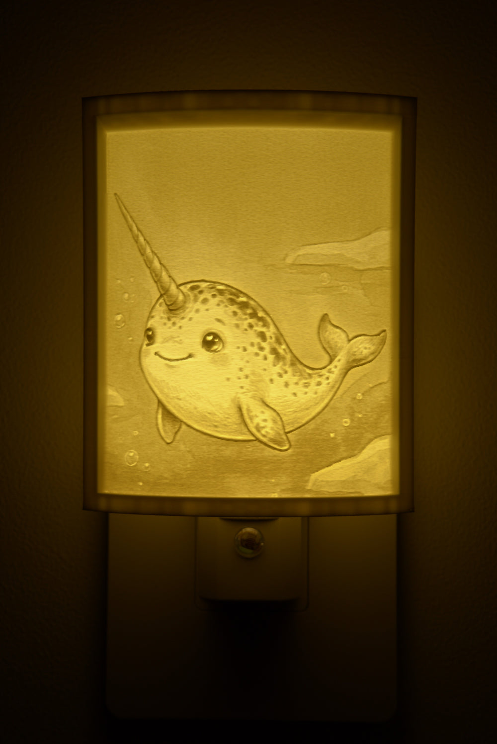Close-up of the narwhal design in warm light