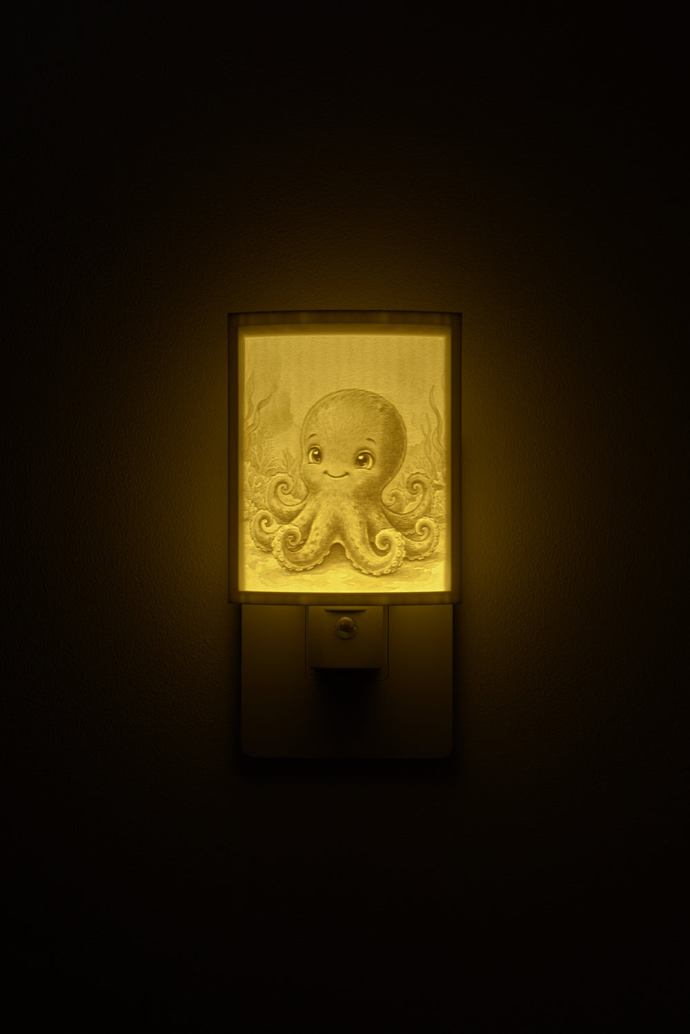 Octopus night light glowing against a dark wall, plugged into an outlet