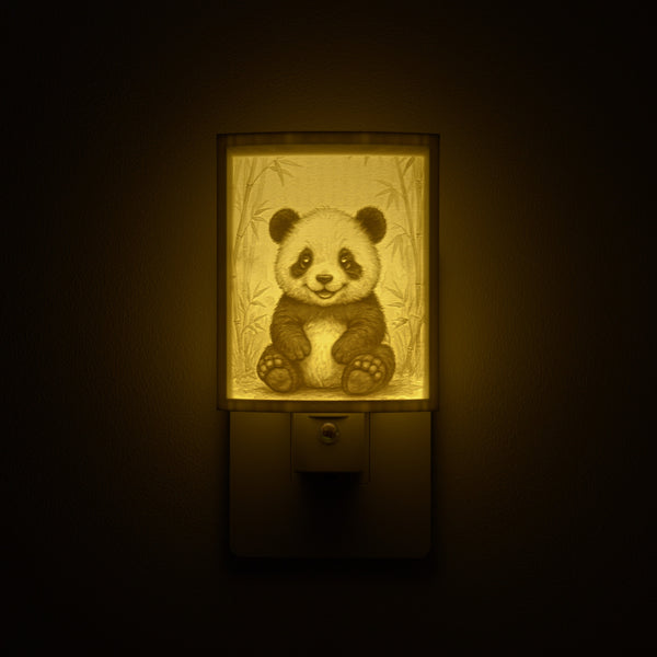 Panda night light glowing against a dark wall, plugged into an outlet