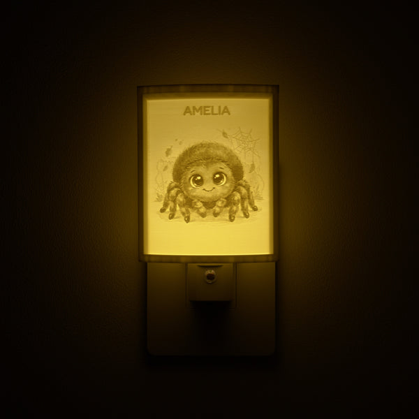 Spider night light glowing with the name AMELIA sculpted into the panel