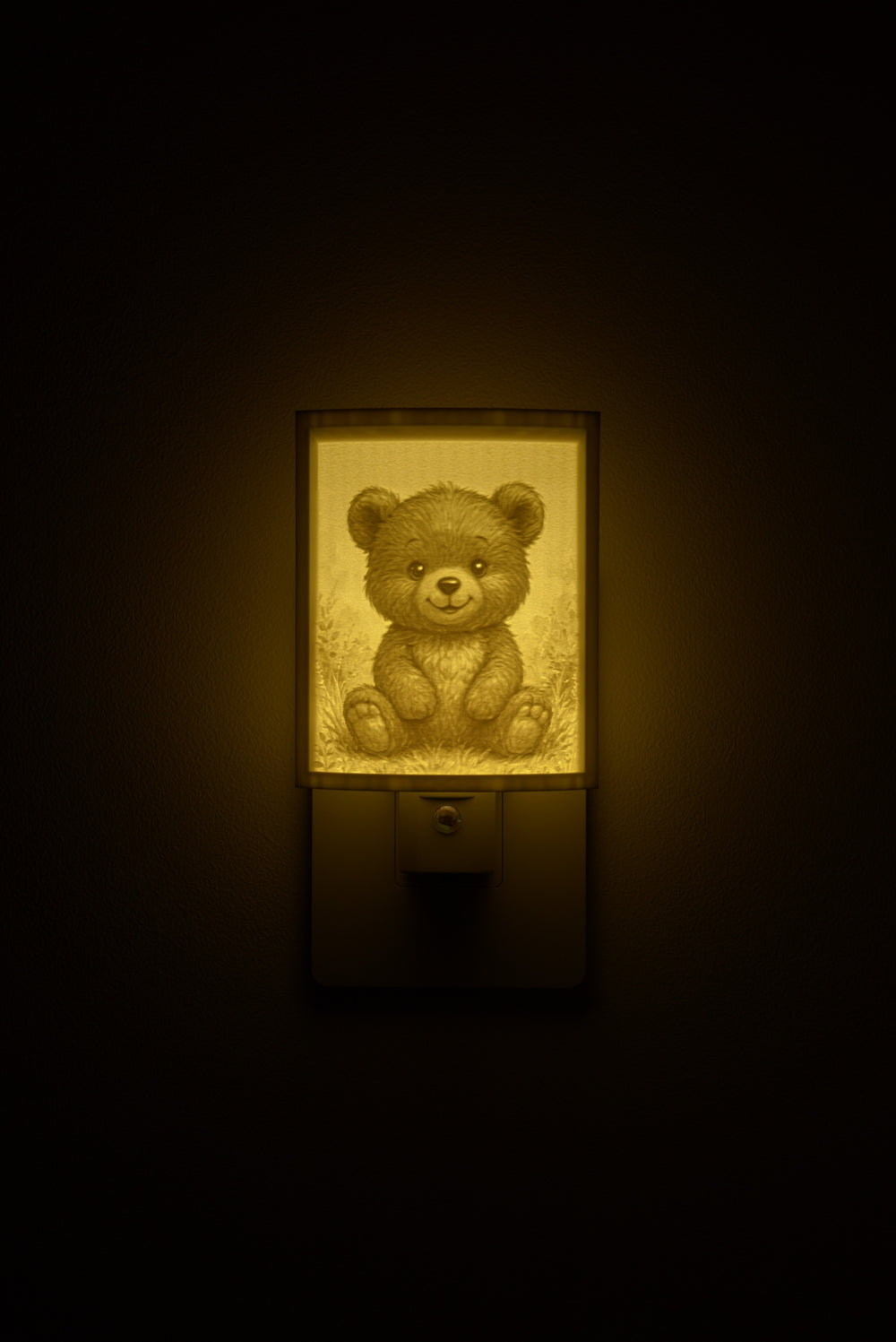 Teddy Bear night light glowing against a dark wall, plugged into an outlet