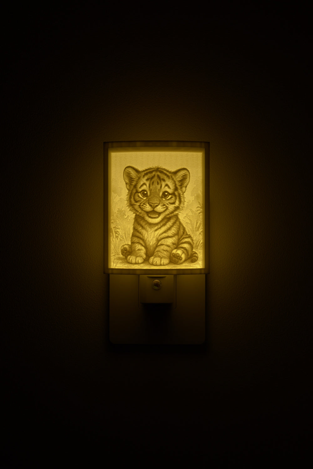 Tiger night light glowing against a dark wall, plugged into an outlet