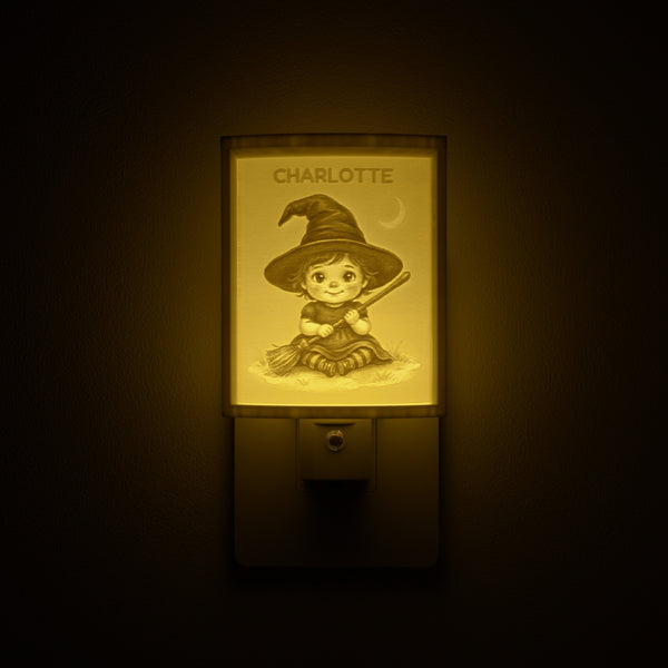 Little Witch night light glowing with the name CHARLOTTE sculpted into the panel