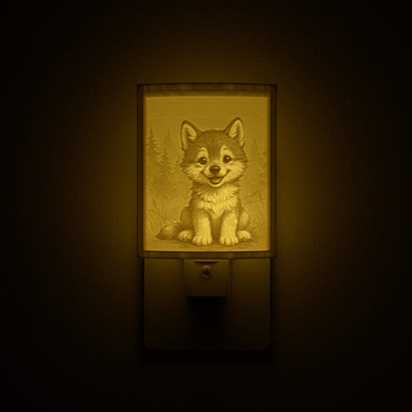 Wolf night light glowing against a dark wall, plugged into an outlet