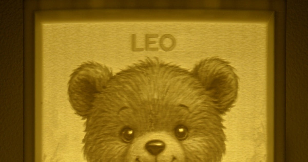 The name LEO embossed at the top of a glowing teddy bear night light
